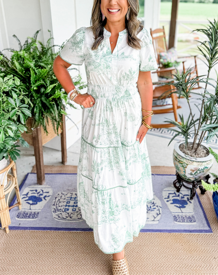 Close-up of the intricate classic toile print on a women's elegant maxi dress. Perfect for spring.