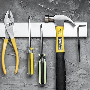 Stainless steel magnetic knife rack for kitchen storage, space-saving utensil holder on wall.