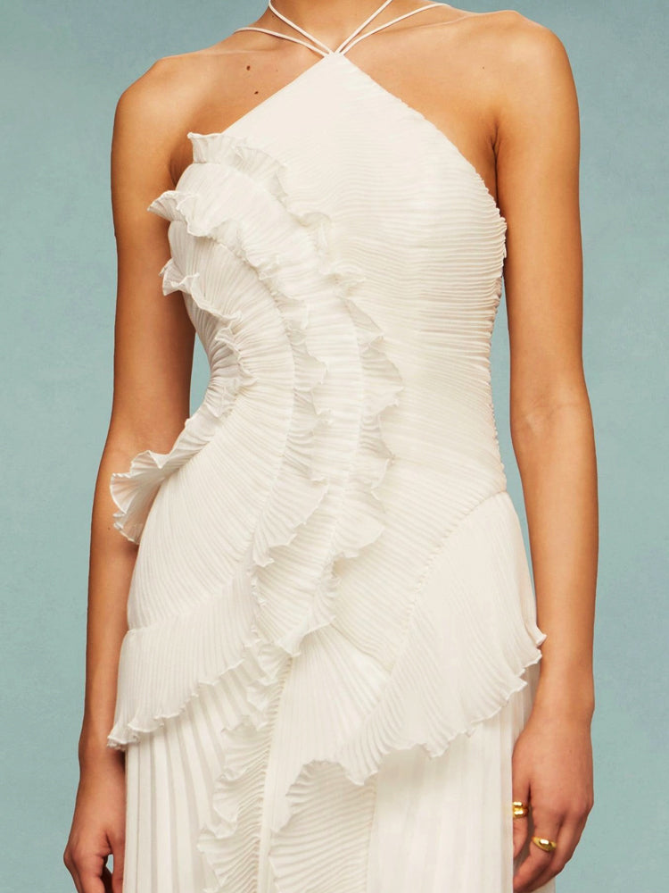 Sleeveless wedding guest maxi dress for women, featuring a chic asymmetric pleated design. Evening wear.