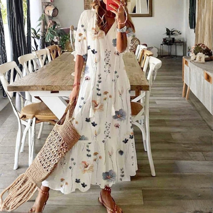 Women's boho maxi dress with a vibrant floral print and short sleeves, perfect for summer casual wear.