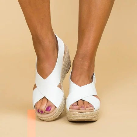 Elegant women's heeled wedge sandals with closed toe. Orthopedic support and comfort for stylish summer footwear.