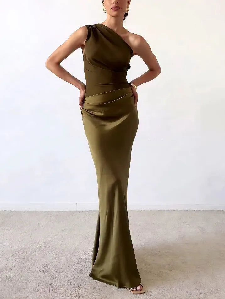 Flowing dark green asymmetric pleated maxi dress for women, ideal as an elegant wedding guest outfit.