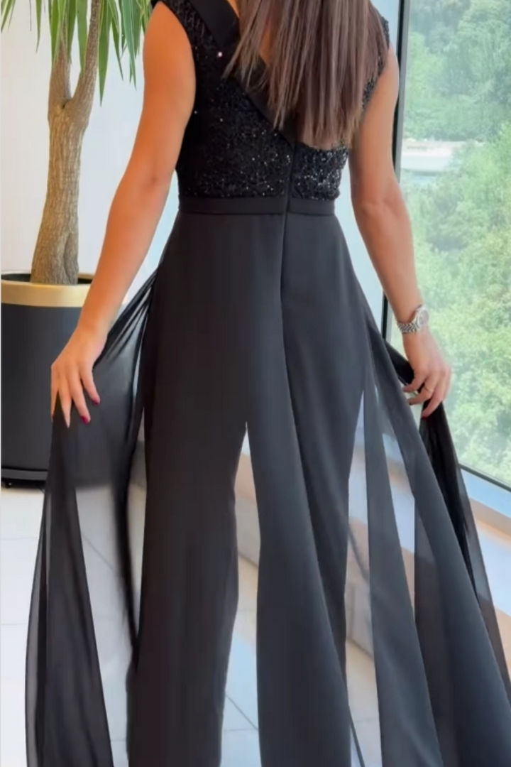 Modern women's textured black jumpsuit, elegant one-piece perfect for versatile office wear or evening chic.