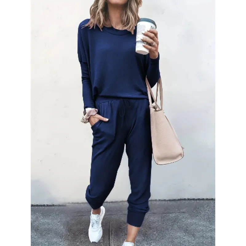 Model in a cozy women's crew neck jogger set, ideal matching outfit for comfortable lounging at home.