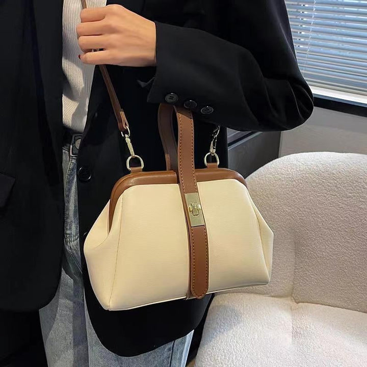 Practical white women's crossbody & shoulder bag with an adjustable strap, top handle for on-the-go style.