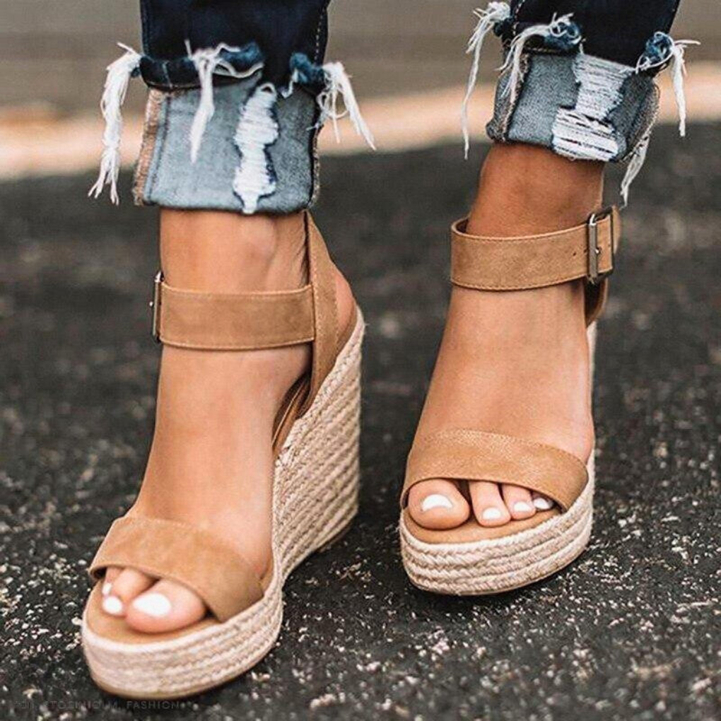 Fashionable women's T-strap wedge sandals, featuring a stylish buckle and comfortable platform sole.