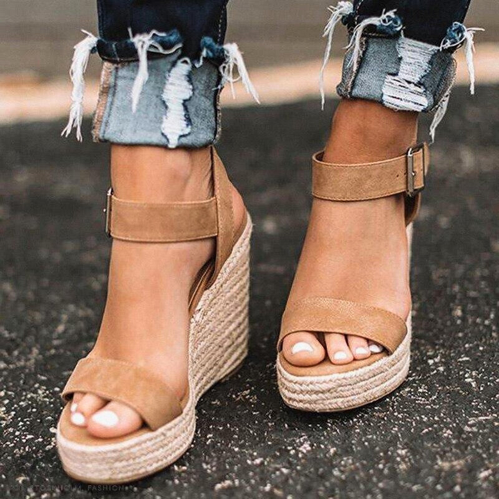 Fashionable women's T-strap wedge sandals, featuring a stylish buckle and comfortable platform sole.