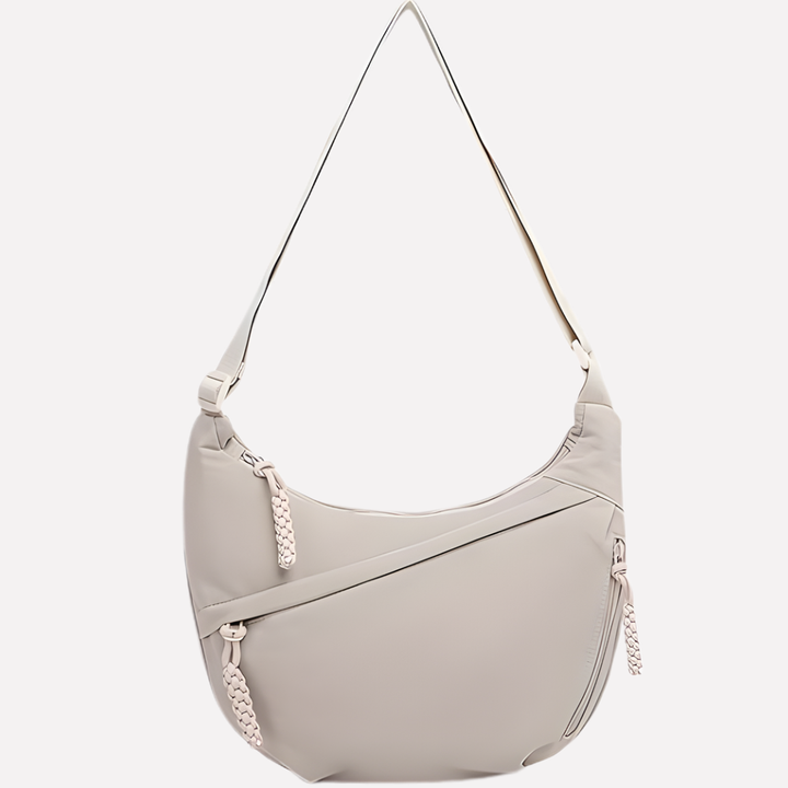 Versatile women's crescent sling bag for travel and everyday essentials, featuring comfortable wear.