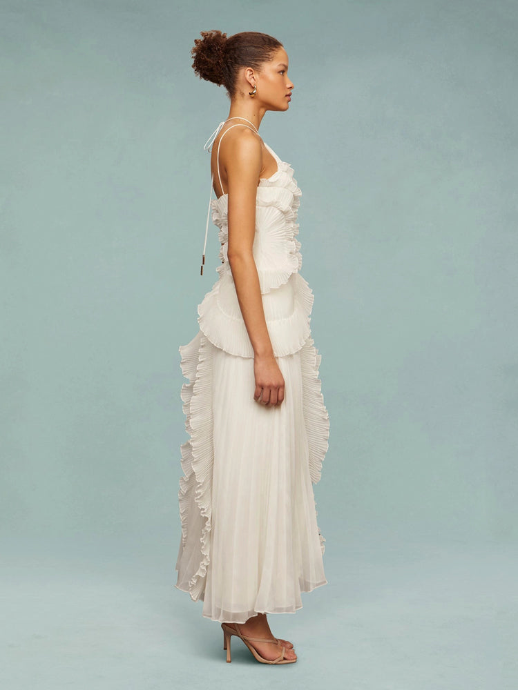 Flowing women's maxi dress, sleeveless with elegant asymmetric pleats, perfect for a wedding guest.