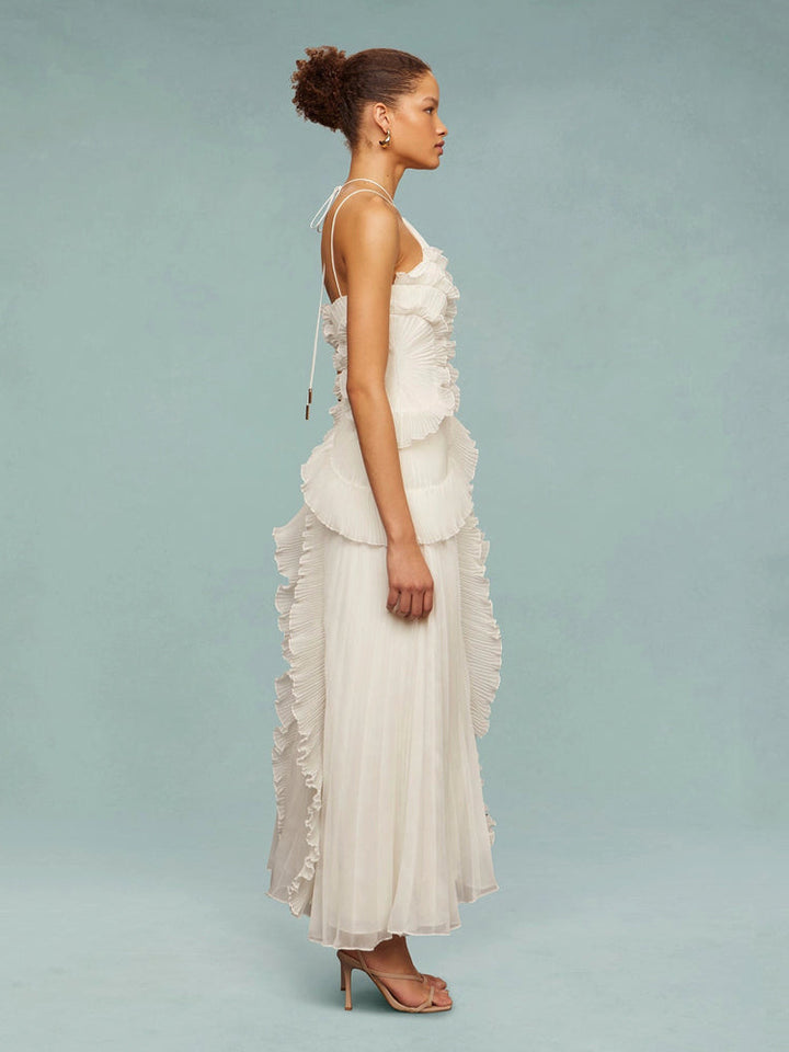 Flowing women's maxi dress, sleeveless with elegant asymmetric pleats, perfect for a wedding guest.