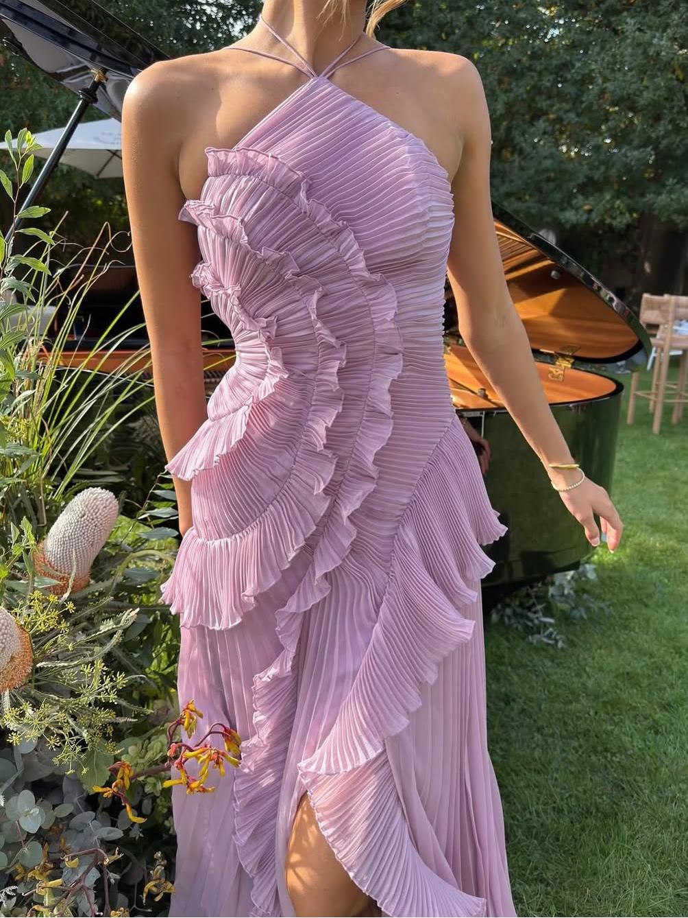 Graceful sleeveless maxi dress for women, perfect as a wedding guest outfit, with intricate asymmetric pleats.