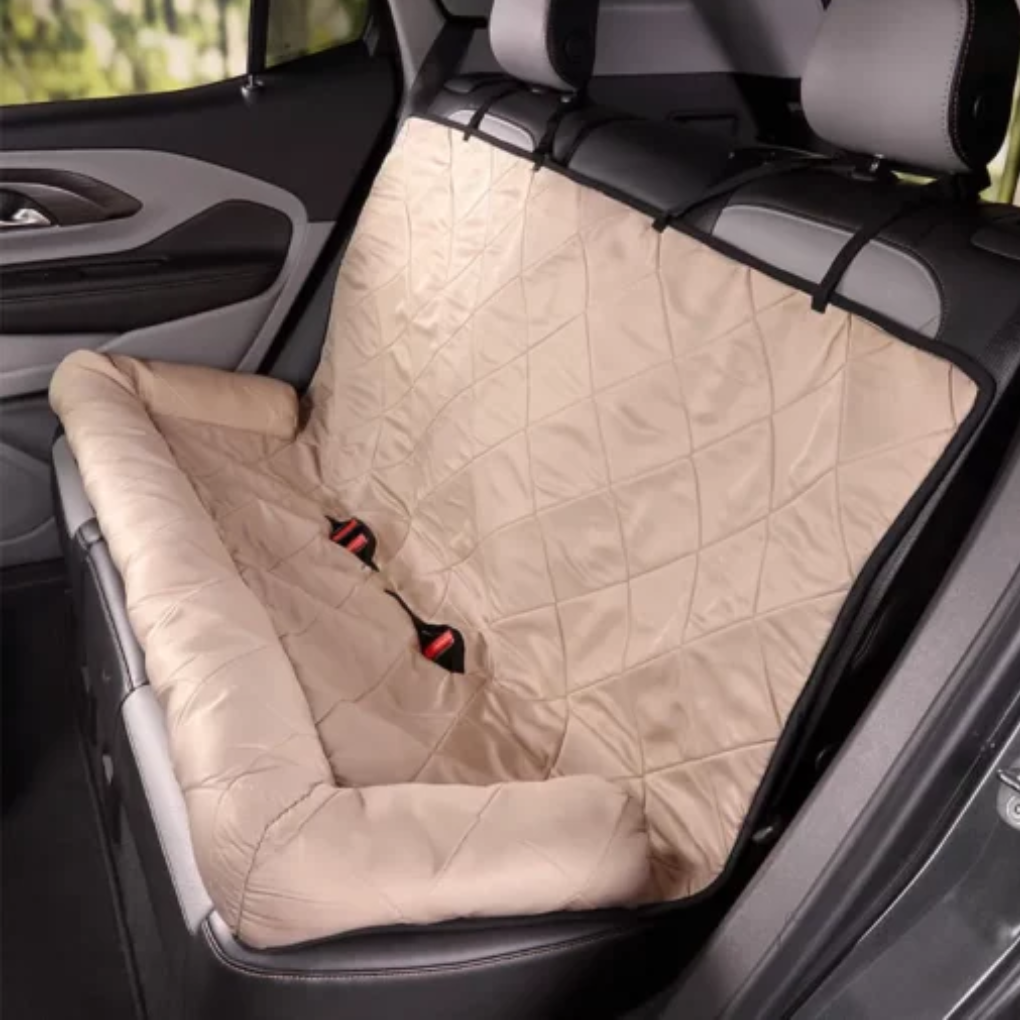 Happy dog safely secured in a comfy, foldable pet car seat. Ideal for travel, this dog bed protects car interior.