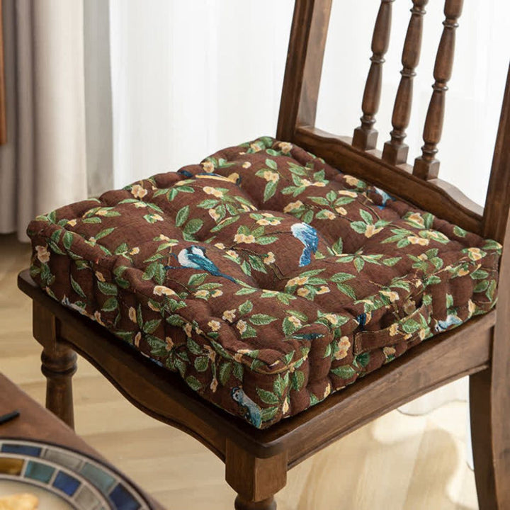 Decorative padded seat cushion with secure ties for dining & patio chairs. Adds comfort & style to home decor.