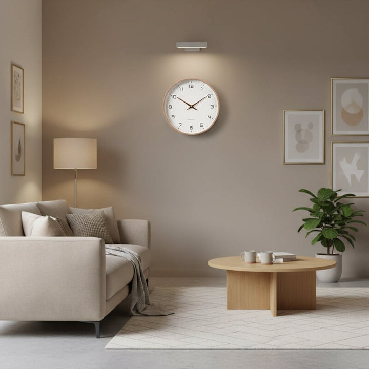Close-up of Scandinavian minimalist wooden wall clock, showcasing smooth beige wood texture. Modern home decor.
