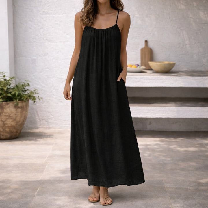 Flowy women's spaghetti strap maxi sundress, great for beach wear or warm summer days.