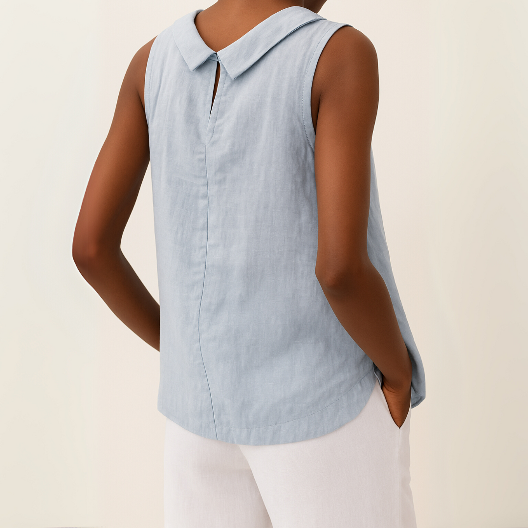 Woman wearing a stylish sleeveless round neck blouse. Casual, relaxed fit top for everyday summer comfort.