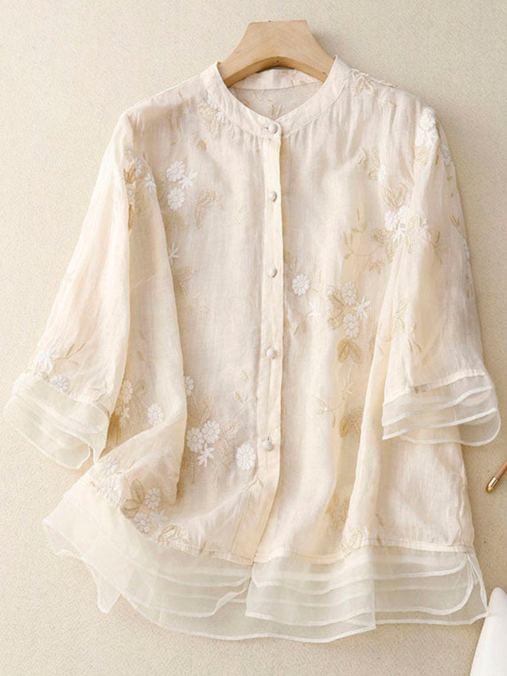 Women's elegant embroidered long sleeve blouse with intricate floral design.