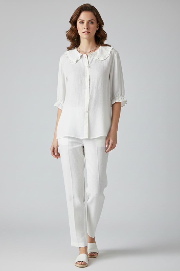 Versatile women's ruffled blouse with button front, ideal for workwear or elegant everyday fashion.