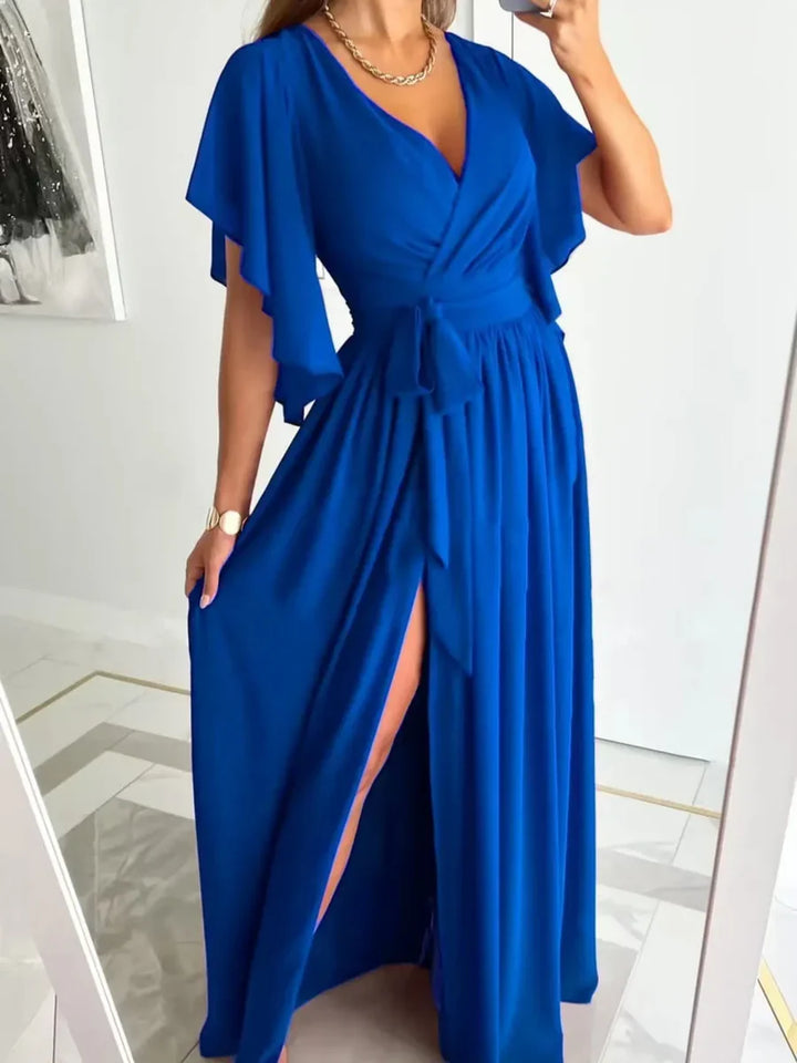 Chic women's V-neck summer dress with airy bell sleeves, designed for elegance and warm weather comfort.