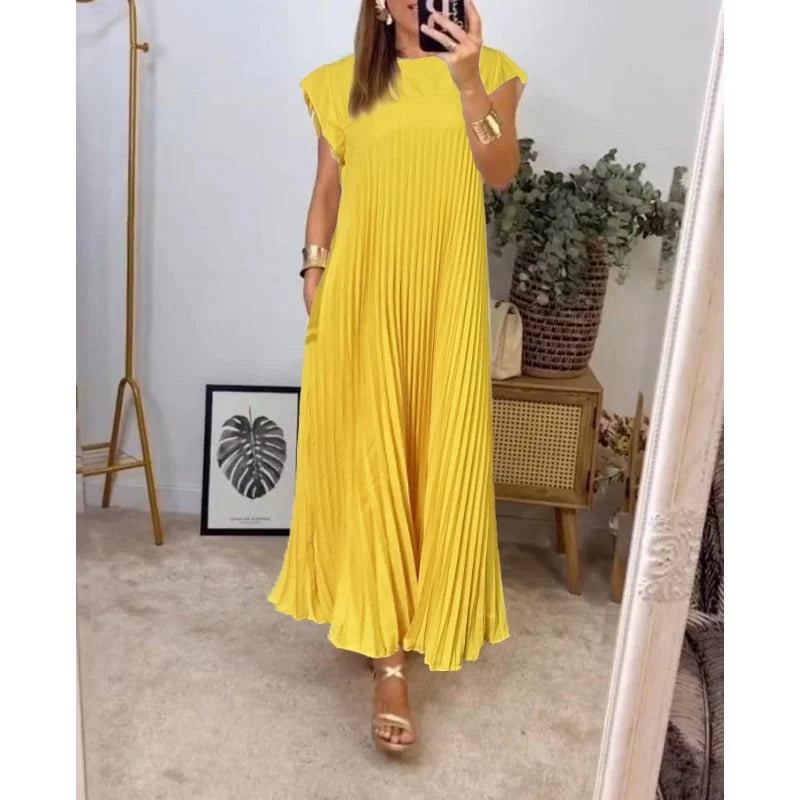 Full-length view of a women's flowing pleated maxi dress, embodying elegant summer style & comfortable design.