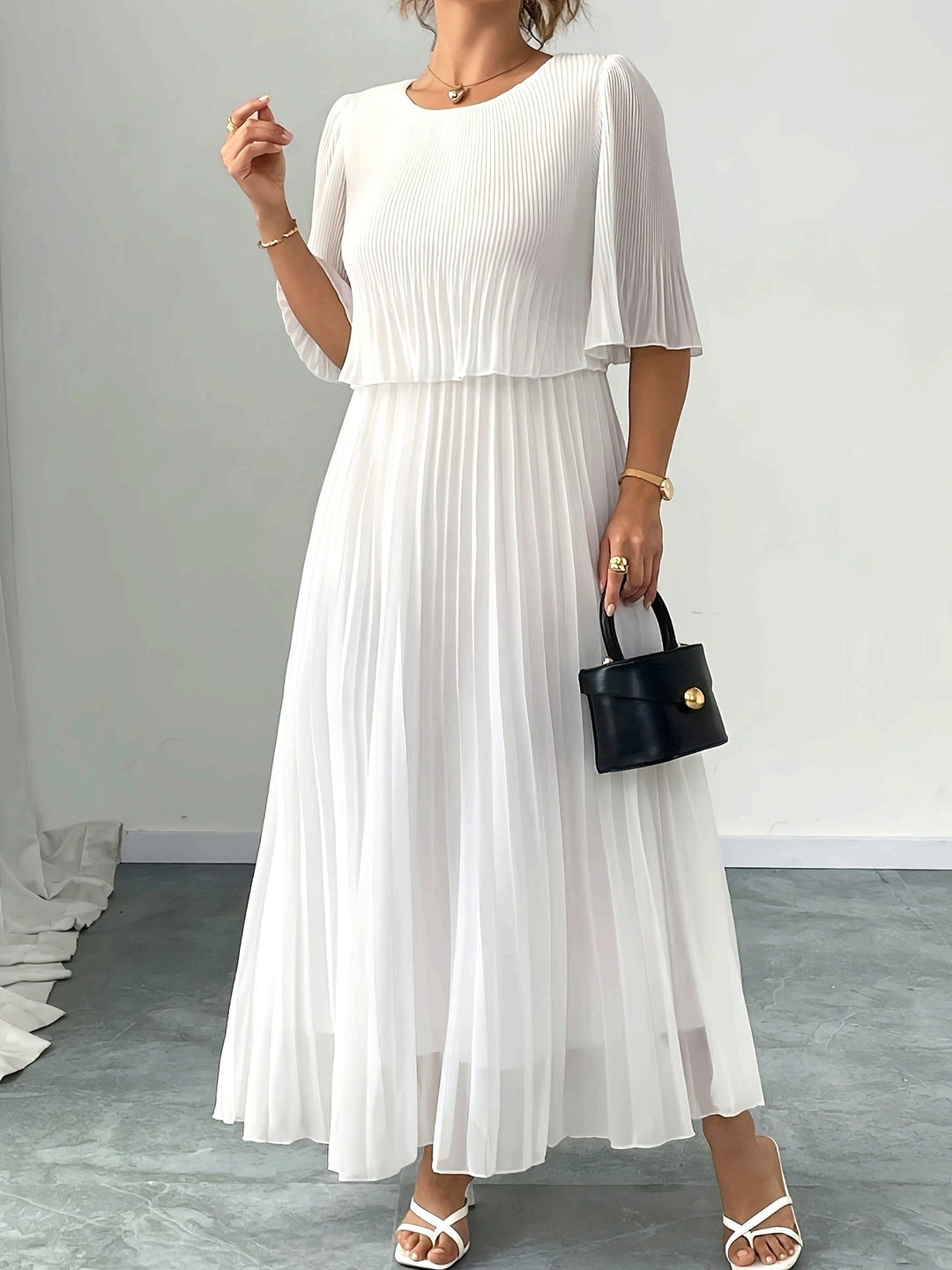 Elegant white pleated A-line maxi dress for women, perfect for a wedding guest or formal special occasion.