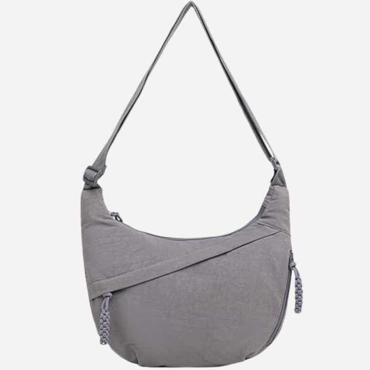 Close-up of textured nylon on women's crescent crossbody bag, durable & lightweight.