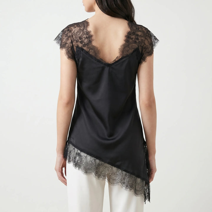 Fashionable women's asymmetrical blouse featuring sheer details & a stylish V-back. Chic summer party top.