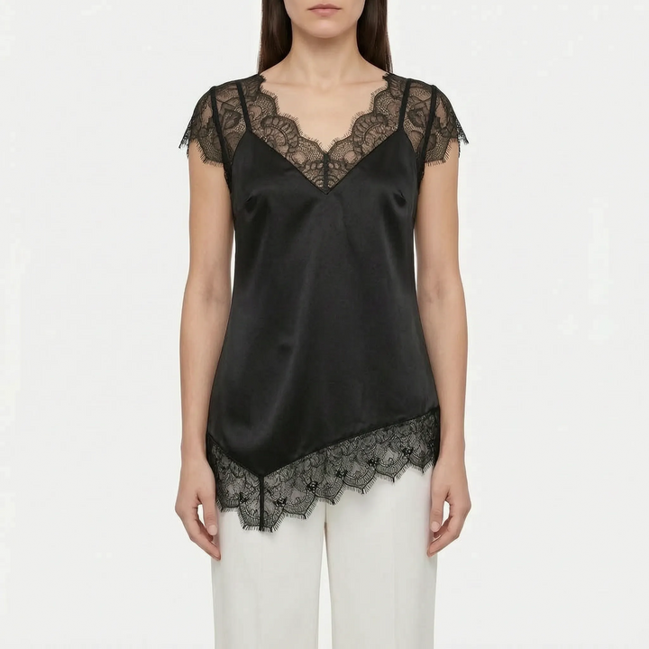 Modern women's elegant asymmetrical top, sleeveless with sheer details. A chic and versatile evening blouse.