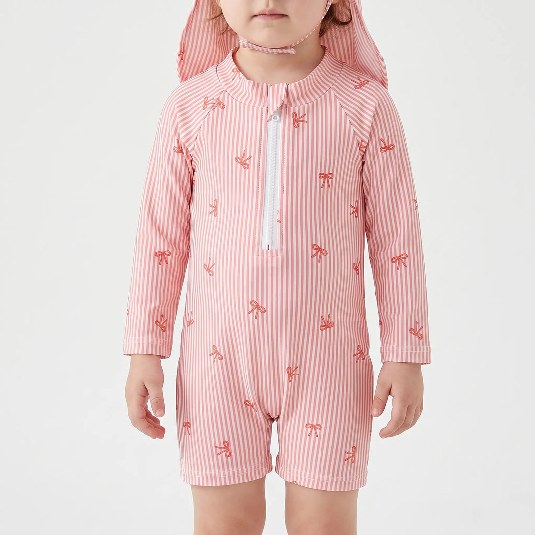 Long-sleeve girls' baby rash guard swimsuit, striped with bow print, designed for toddler and infant sun protection by the pool.