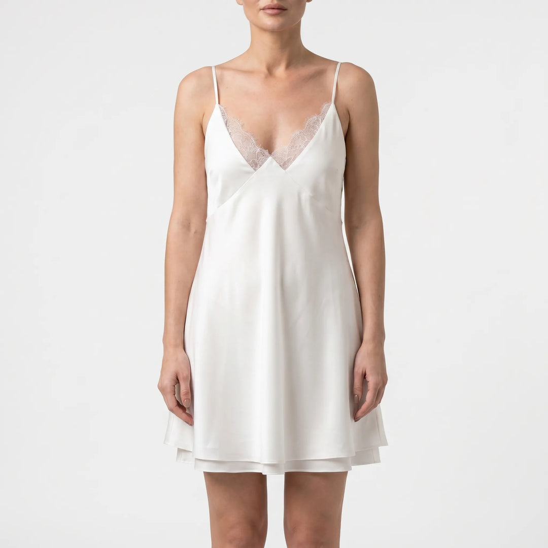 Fashionable women's white backless mini dress, a trendy summer style with delicate spaghetti straps for events.