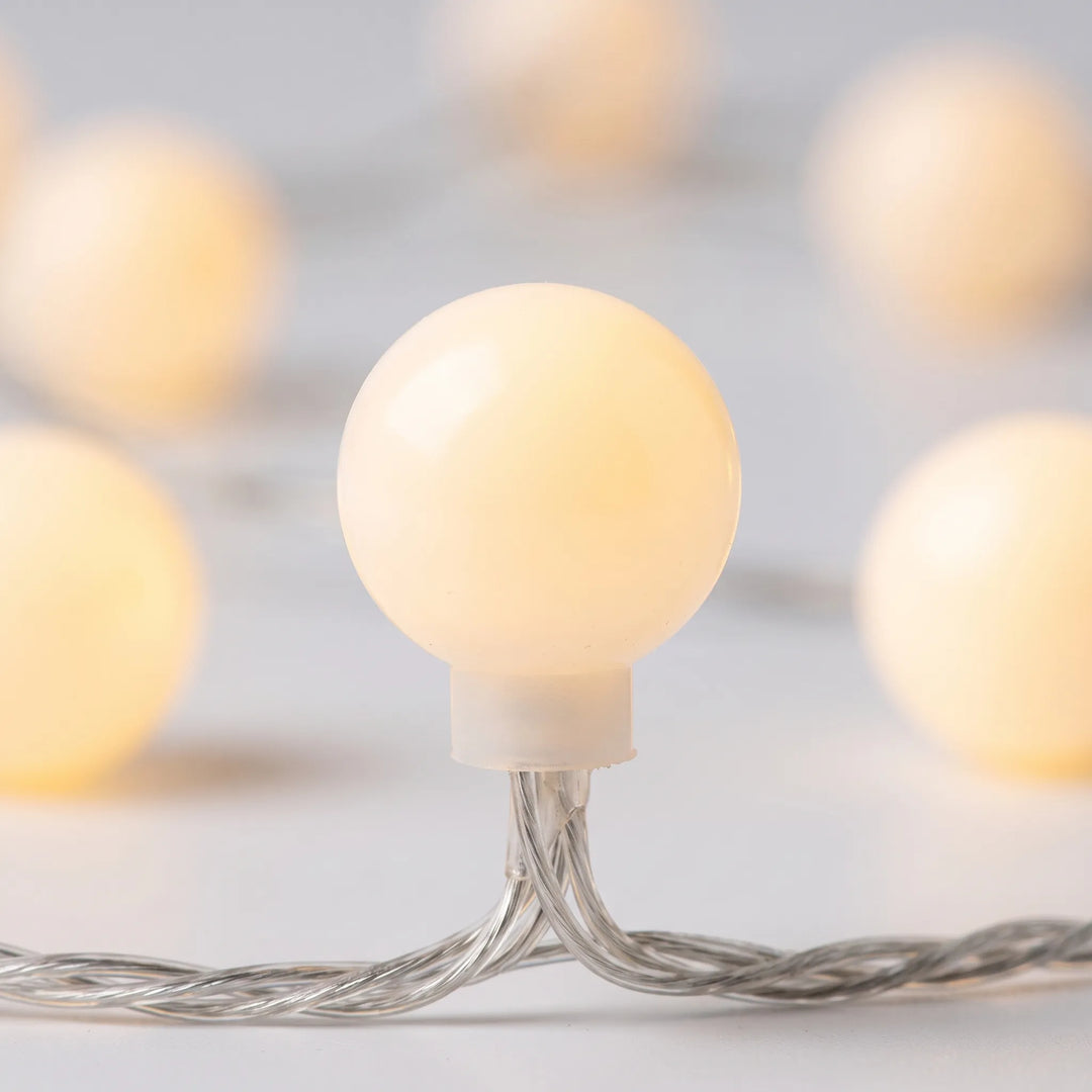 Warm white LED globe string lights, creating a soft, cozy glow for indoor & outdoor spaces.