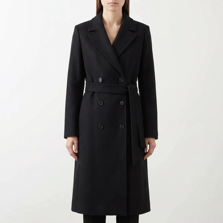 Women's elegant long coat with double-breasted front and belted waist, a classic winter fashion statement.