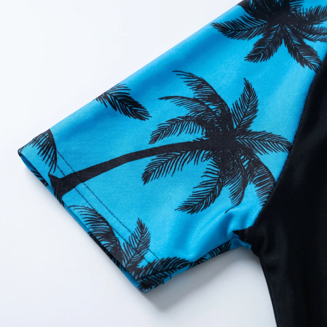 Kids' blue two-piece swim set with patterned top. Comfortable boys' swimwear for ocean and pool fun.