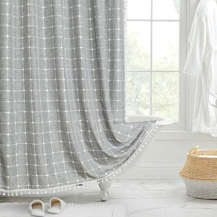 Close-up of elegant tassels on a Bohemian Farmhouse shower curtain, showcasing rustic texture & detailed design.
