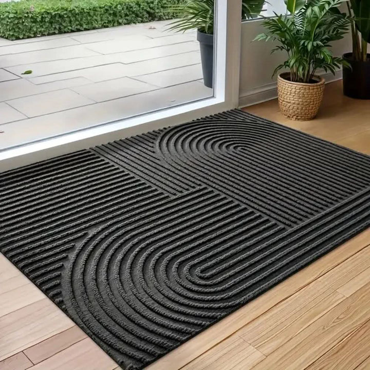 High-quality absorbent floor mat, washable and non-slip, with a modern flowing line design. Home decor accent.