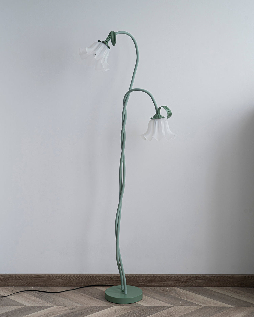 Tall green botanical floor lamp with a classic white shade, modern floral decor piece.