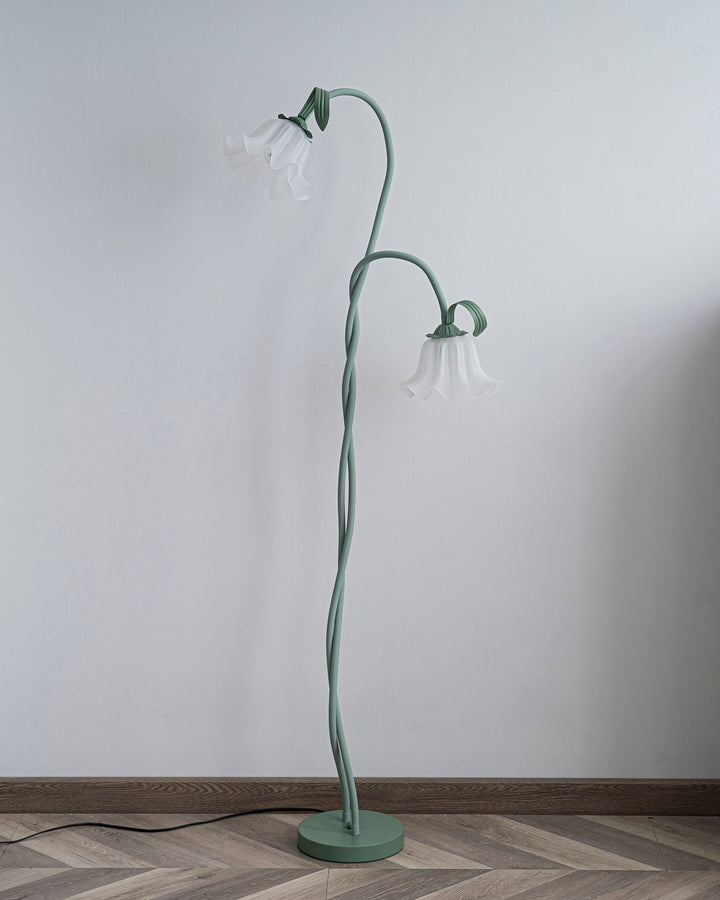 Tall green botanical floor lamp with a classic white shade, modern floral decor piece.