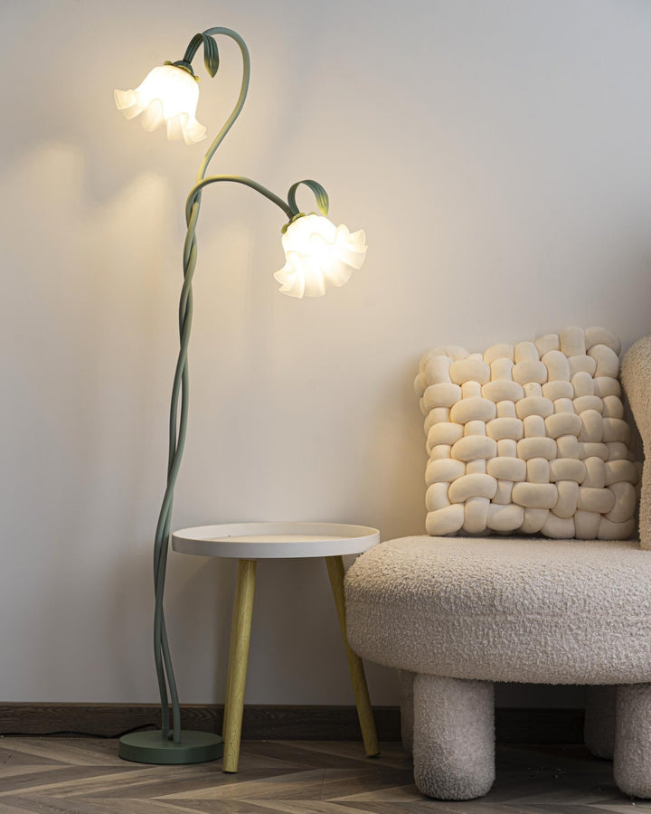 Stylish green floral floor lamp with a modern base and a contrasting white shade.