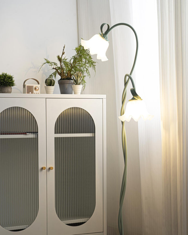 Green botanical floor lamp, artistic floral pattern, white shade, modern lighting.