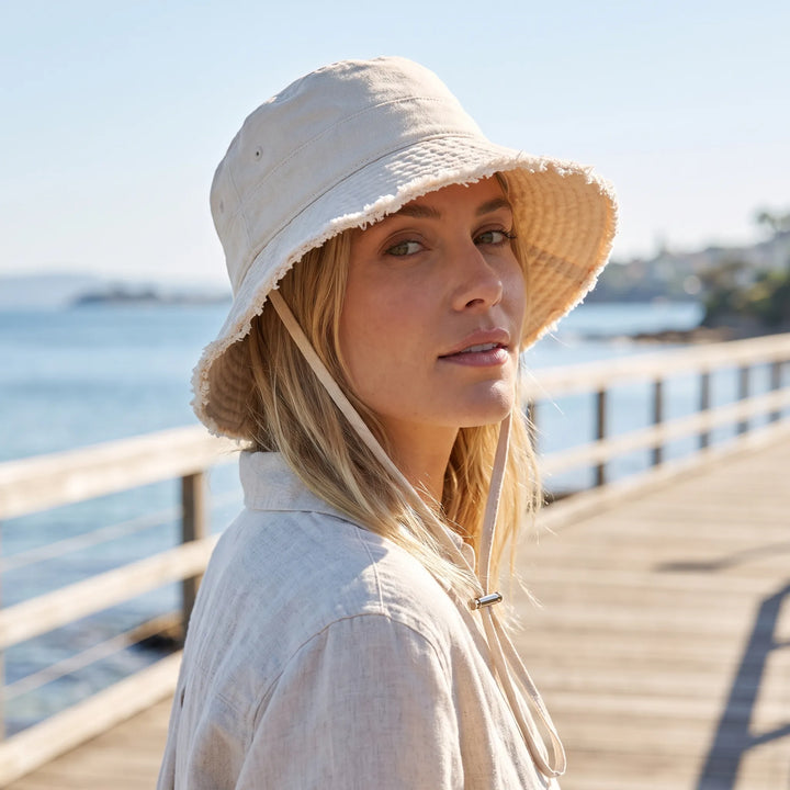 Women's casual bucket hat with adjustable chin strap, perfect for summer sun protection & beachwear.