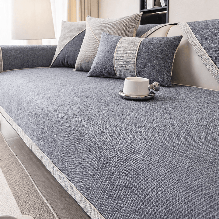 Quilted non-slip sofa cover for ultimate couch protection. Pet-friendly cotton-linen furniture cover in a neutral hue.
