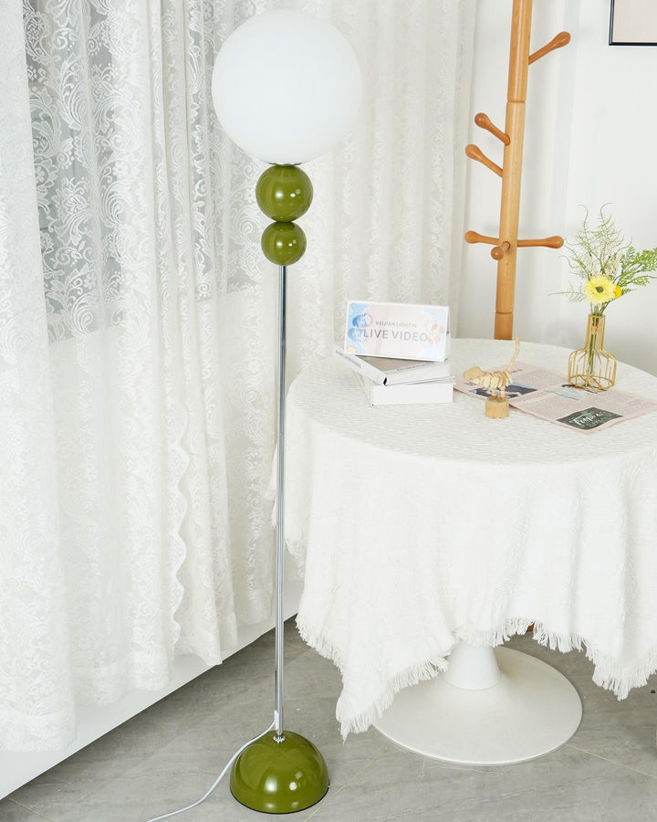 Contemporary green floor lamp, metal and glass, perfect for a cozy bedroom light.