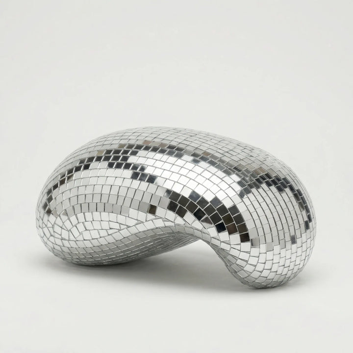 Unique LustraCurl tabletop sculpture, a modern light art piece creating dynamic reflections for living room or office.