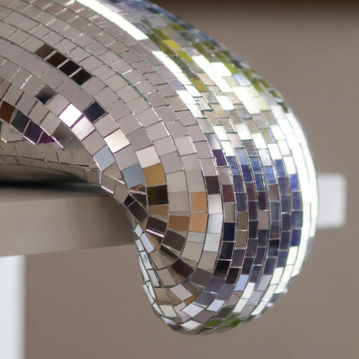 Reflective LustraCurl tabletop sculpture; contemporary decor with dynamic light play, perfect for modern home accents.