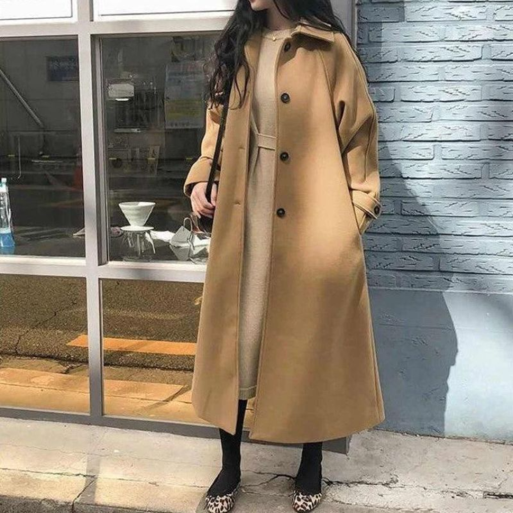 Classic women's long coat in elegant beige, ideal for fall/winter outerwear. Stylish workwear and formal coat.