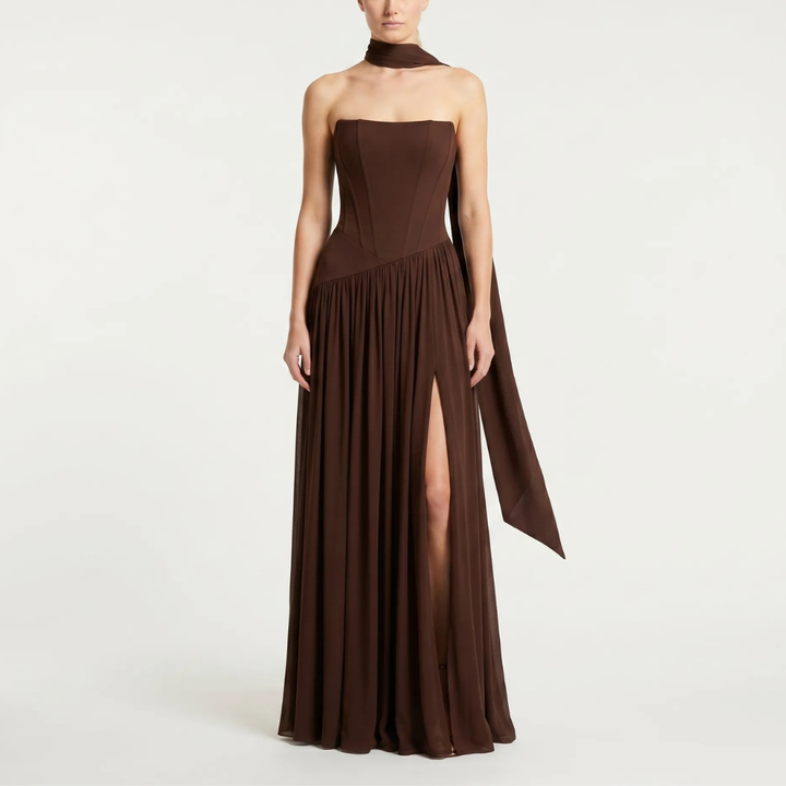 Long strapless maxi dress featuring a structured corset design, an elegant choice for wedding guests.