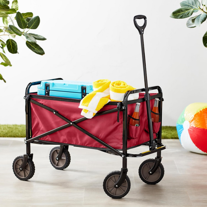 Collapsible utility wagon folded compactly for storage, demonstrating portable transport for gear, tools & supplies.