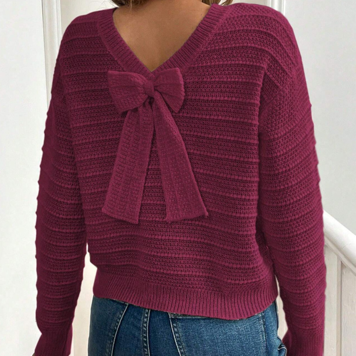 Relaxed fit women's pullover sweater with a stylish bow back. Ideal long sleeve, round neck top for fall fashion.