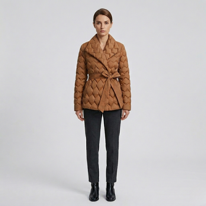Elegant women's belted down coat for winter warmth. Long, quilted design perfect for cold weather fashion.