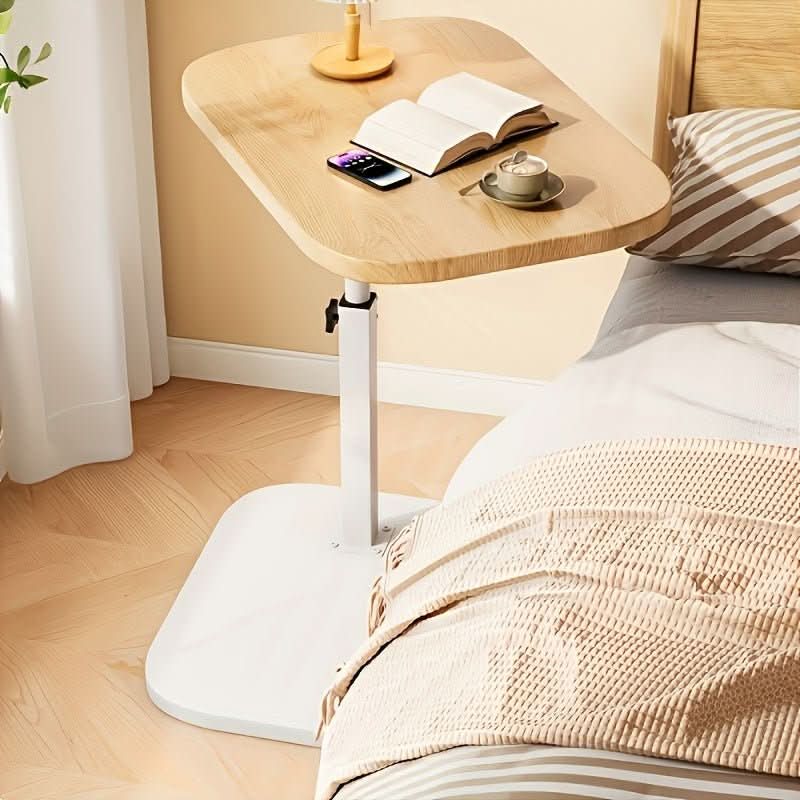 Modern adjustable side table for sofa & bed. Versatile, portable, space-saving living room & bedroom furniture.